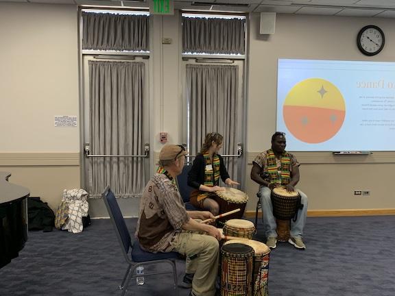 Three individuals drumming